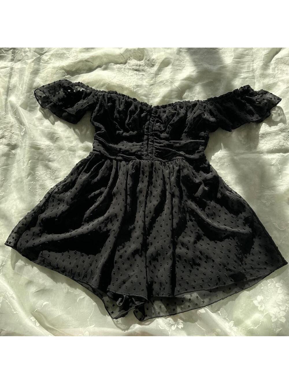Black polka dot off the shoulder romper with polka dot patterned fabric
